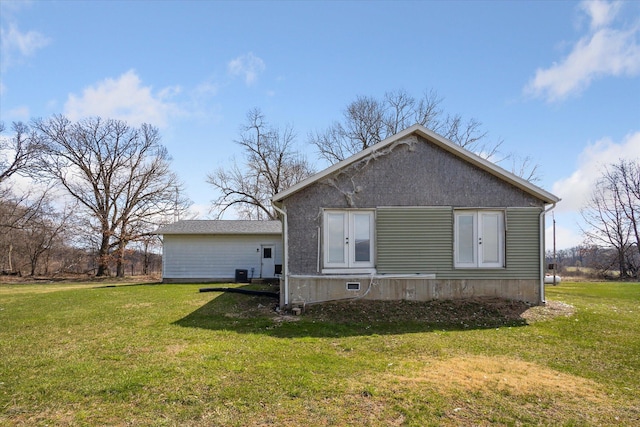 rear view of property with a yard