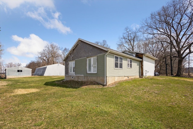 view of side of property with a yard