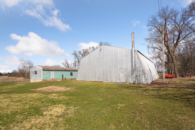 view of pole building with a yard