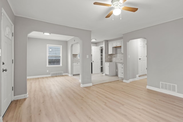 19319 Huntington Rd, Detroit, MI 48219 - unfurnished living room with ceiling fan, arched walkways, visible vents, and light wood-style flooring