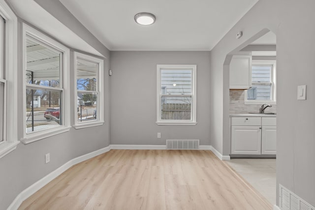 19319 Huntington Rd, Detroit, MI 48219 - unfurnished dining area with a wealth of natural light, a sink, and visible vents