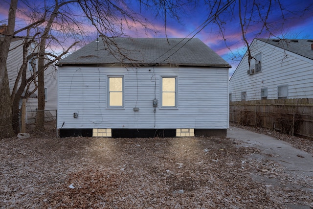 19319 Huntington Rd, Detroit, MI 48219 - back of property at dusk featuring roof with shingles and fence