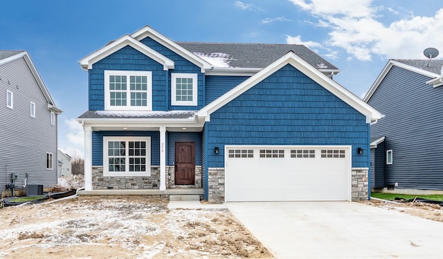 5192 Rolling Hills Dr, Grand Blanc, MI 48439 - craftsman inspired home with a shingled roof, concrete driveway, an attached garage, stone siding, and a porch