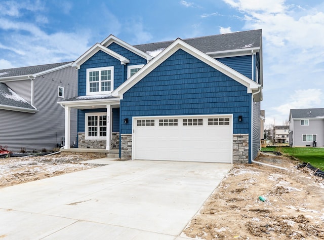 5192 Rolling Hills Dr, Grand Blanc, MI 48439 - craftsman-style home with covered porch, an attached garage, stone siding, and concrete driveway