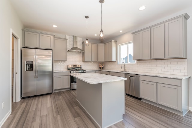 5192 Rolling Hills Dr, Grand Blanc, MI 48439 - kitchen with wood finished floors, a sink, wall chimney exhaust hood, gray cabinetry, and appliances with stainless steel finishes