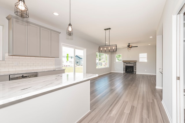5192 Rolling Hills Dr, Grand Blanc, MI 48439 - kitchen featuring stainless steel dishwasher, light wood-style floors, backsplash, gray cabinetry, and ceiling fan