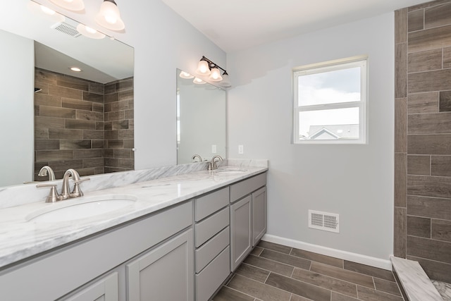 5192 Rolling Hills Dr, Grand Blanc, MI 48439 - bathroom with a sink, visible vents, and double vanity