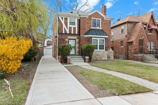 19319 Pennington Dr, Detroit, MI 48221 - tudor house with a chimney, a garage, a shingled roof, an outdoor structure, and a front yard