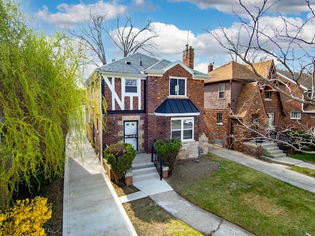 19319 Pennington Dr, Detroit, MI 48221 - view of front of home featuring roof with shingles, a chimney, a front lawn, brick siding, and a standing seam roof
