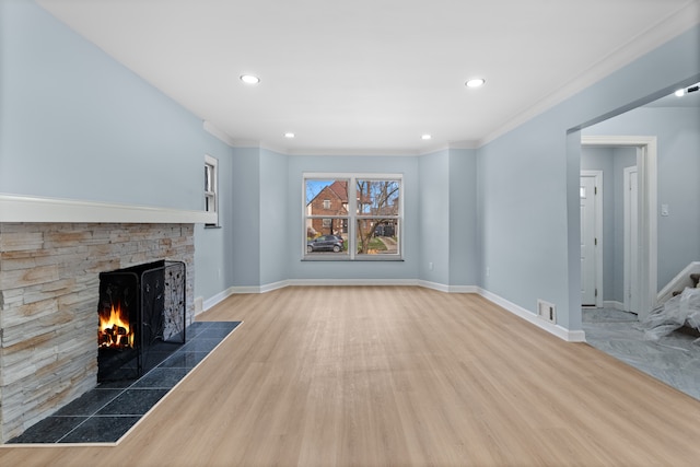 19319 Pennington Dr, Detroit, MI 48221 - unfurnished living room with baseboards, wood finished floors, a stone fireplace, and visible vents