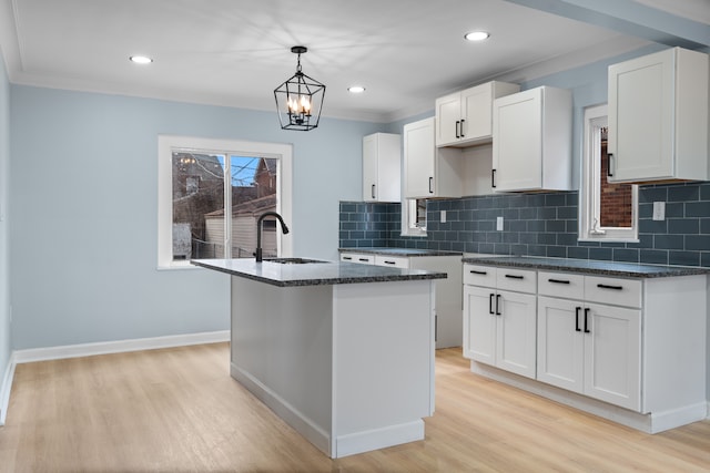 19319 Pennington Dr, Detroit, MI 48221 - kitchen with decorative backsplash, recessed lighting, a sink, and light wood-style floors