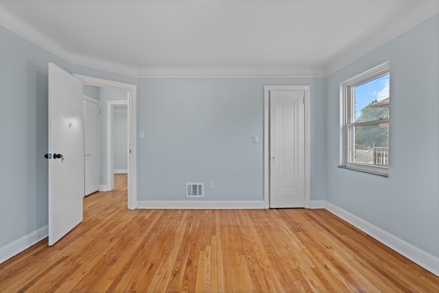 19319 Pennington Dr, Detroit, MI 48221 - spare room featuring light wood finished floors, baseboards, visible vents, and crown molding