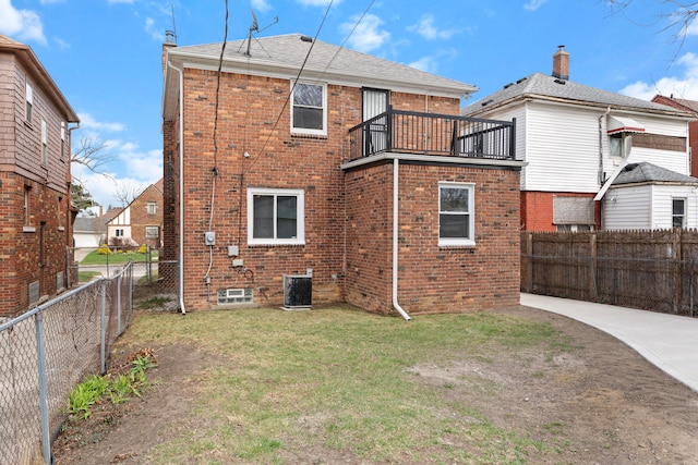 19319 Pennington Dr, Detroit, MI 48221 - back of house featuring a fenced backyard, brick siding, a yard, and central air condition unit