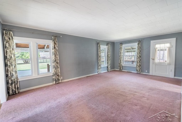 spare room with baseboards and carpet