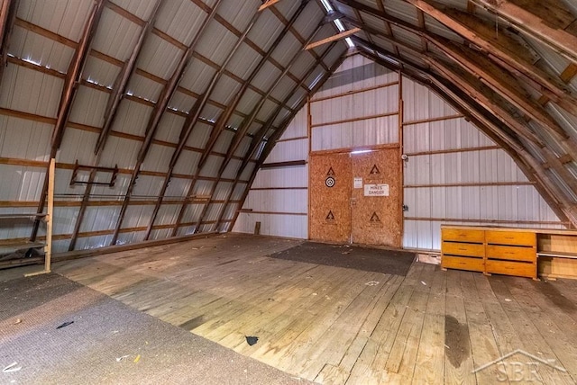 misc room with a garage and wood-type flooring