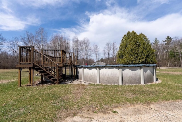 view of yard with a wooden deck, stairway, and an outdoor pool