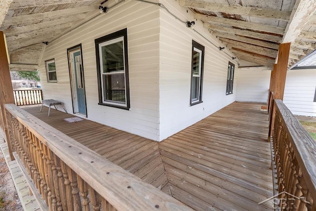wooden terrace featuring covered porch