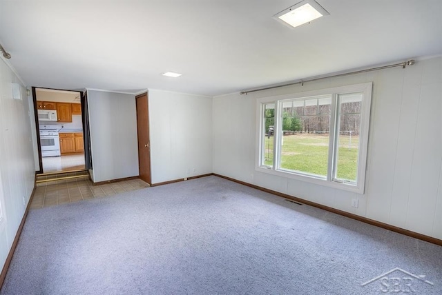 empty room with visible vents, baseboards, and light carpet