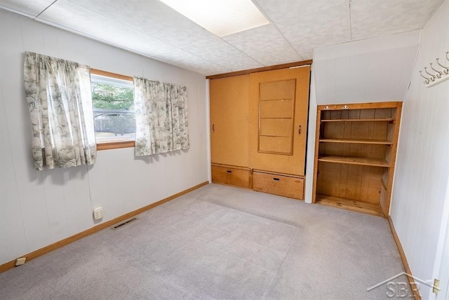 interior space featuring baseboards, visible vents, carpet, and a closet