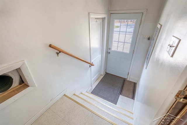 doorway to outside with baseboards