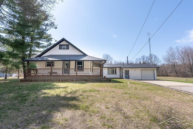 farmhouse inspired home featuring a shingled roof, a front lawn, concrete driveway, an attached garage, and covered porch
