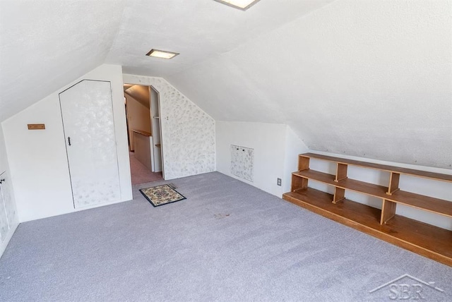 additional living space with carpet floors and lofted ceiling