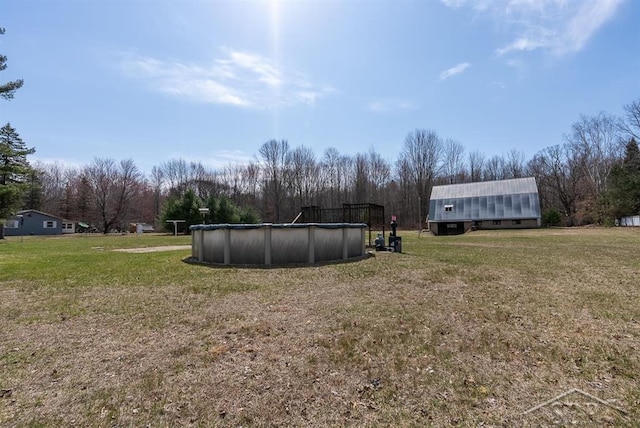 view of yard with a covered pool
