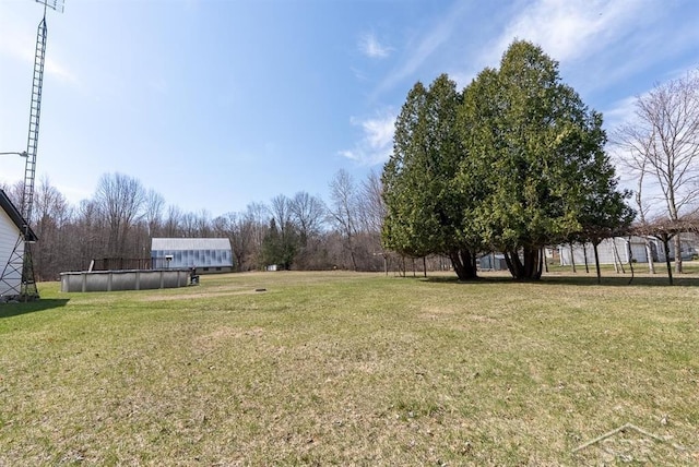 view of yard featuring an outdoor pool