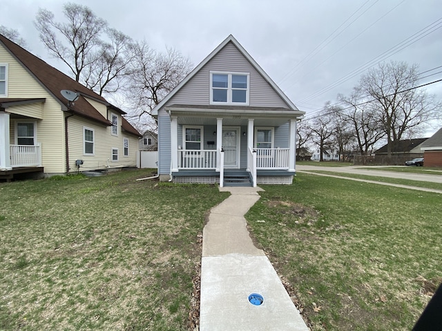 bungalow-style house featuring a porch and a front lawn