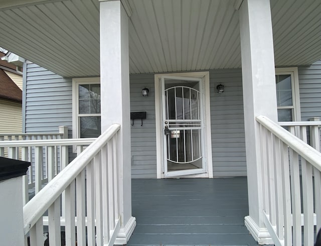 view of exterior entry with covered porch