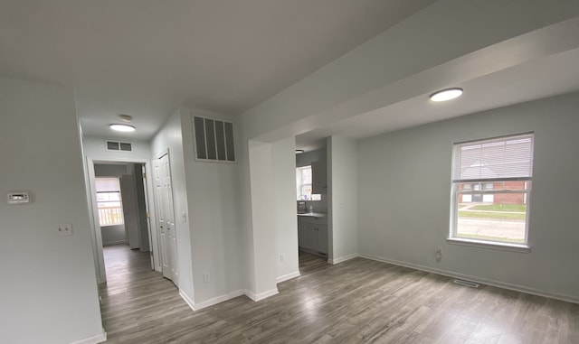 empty room with a healthy amount of sunlight and visible vents