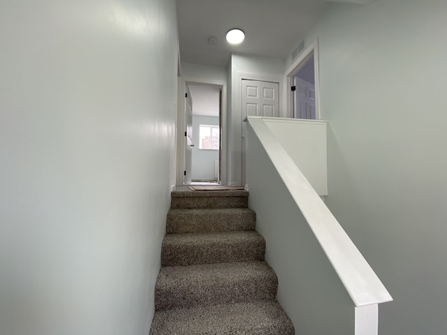 stairway featuring visible vents