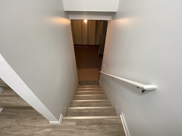 stairs with baseboards and wood finished floors