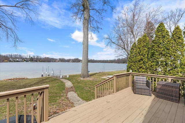 deck with a lawn and a water view