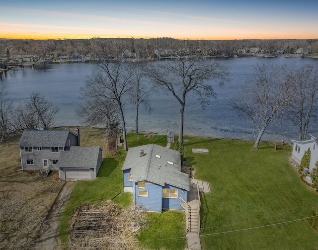 birds eye view of property with a water view