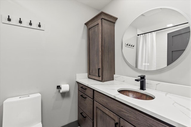 full bath with baseboards, toilet, and vanity