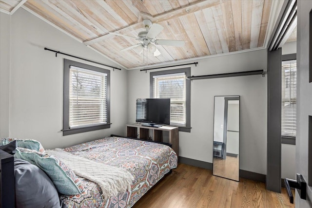 bedroom featuring baseboards, wood finished floors, lofted ceiling, and wood ceiling