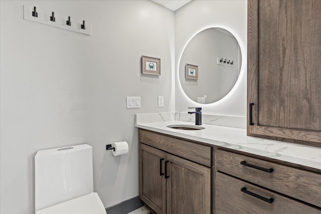 half bathroom featuring toilet and vanity