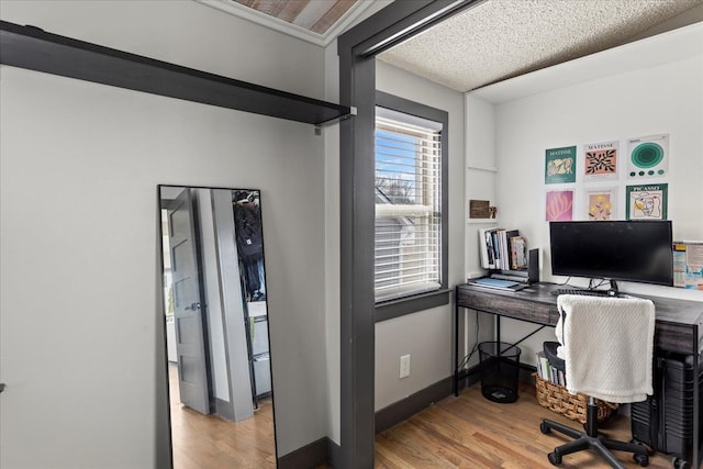 home office featuring baseboards and wood finished floors