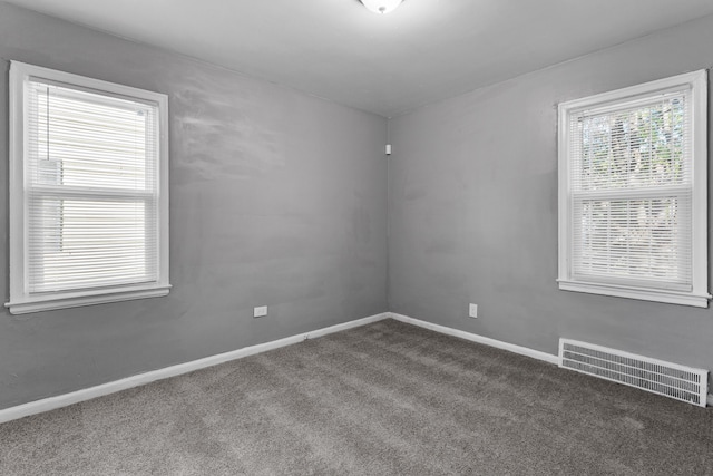 carpeted spare room with baseboards and visible vents