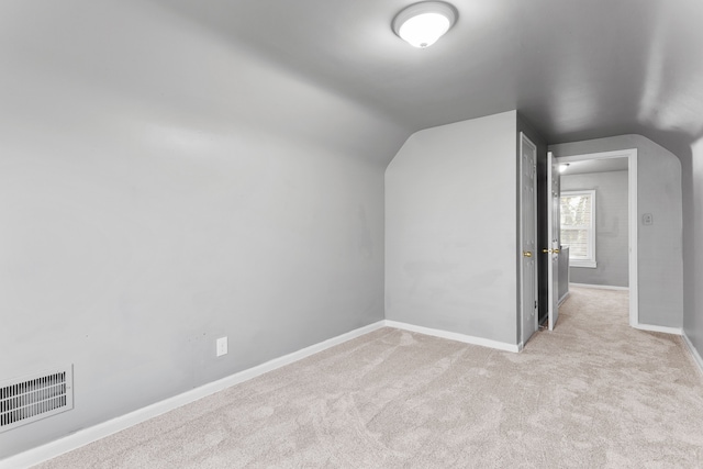 bonus room with baseboards, lofted ceiling, visible vents, and carpet floors
