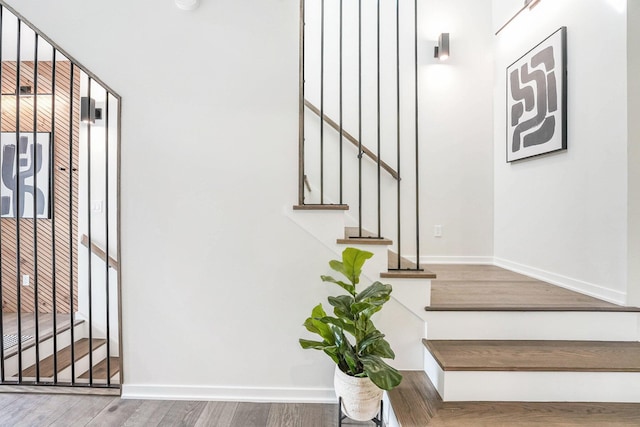 2359 Elinor Ln SE, East Grand Rapids, MI 49506 - stairway featuring baseboards and wood finished floors