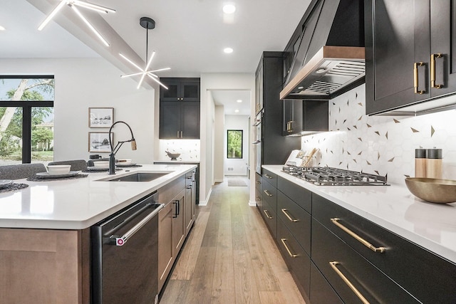 2359 Elinor Ln SE, East Grand Rapids, MI 49506 - kitchen with wall chimney range hood, a sink, light countertops, light wood-style flooring, and dishwashing machine