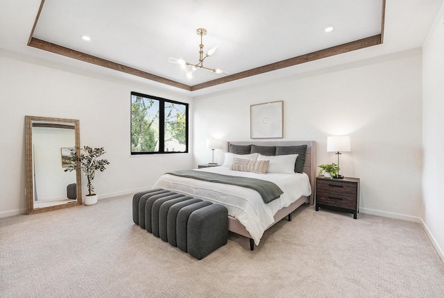 2359 Elinor Ln SE, East Grand Rapids, MI 49506 - bedroom featuring baseboards, a tray ceiling, an inviting chandelier, and light colored carpet