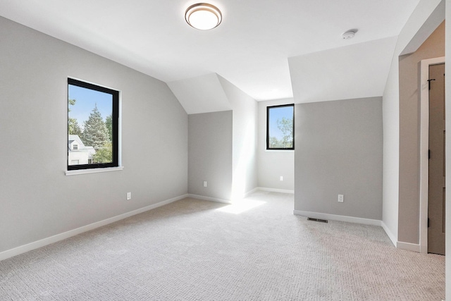 2359 Elinor Ln SE, East Grand Rapids, MI 49506 - bonus room featuring baseboards, vaulted ceiling, visible vents, and light carpet