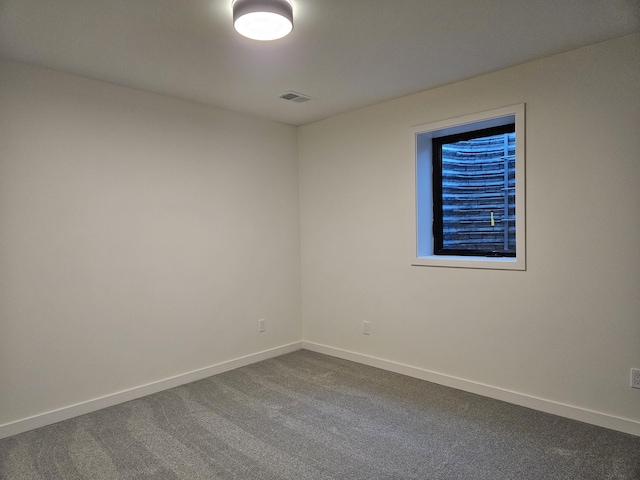 2359 Elinor Ln SE, East Grand Rapids, MI 49506 - spare room with baseboards, visible vents, and dark carpet