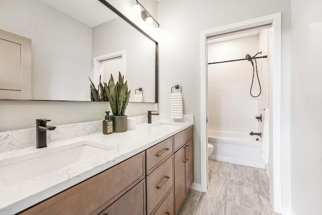 2359 Elinor Ln SE, East Grand Rapids, MI 49506 - bathroom featuring toilet, a sink, double vanity, and bathing tub / shower combination