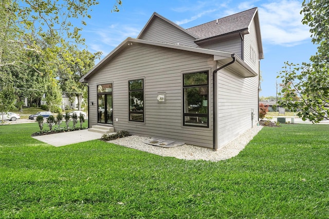 2359 Elinor Ln SE, East Grand Rapids, MI 49506 - back of house with a lawn and roof with shingles