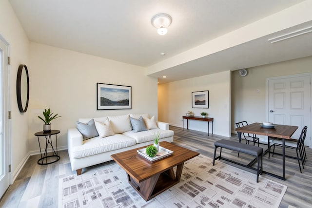 living area with light wood finished floors, baseboards, and recessed lighting