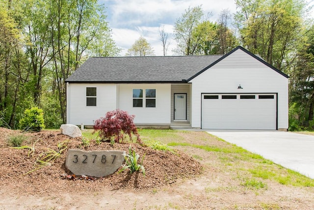 view of front of property featuring an attached garage and concrete driveway